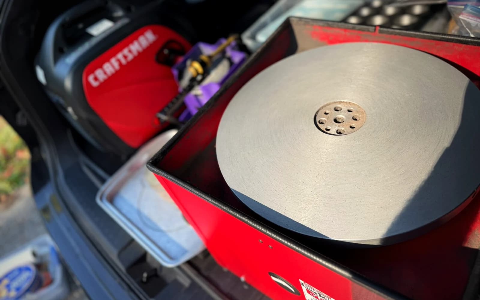 Horizontal cast-iron sharpening platter on the Edge Pro CS-201 machine inside the mobile workshop